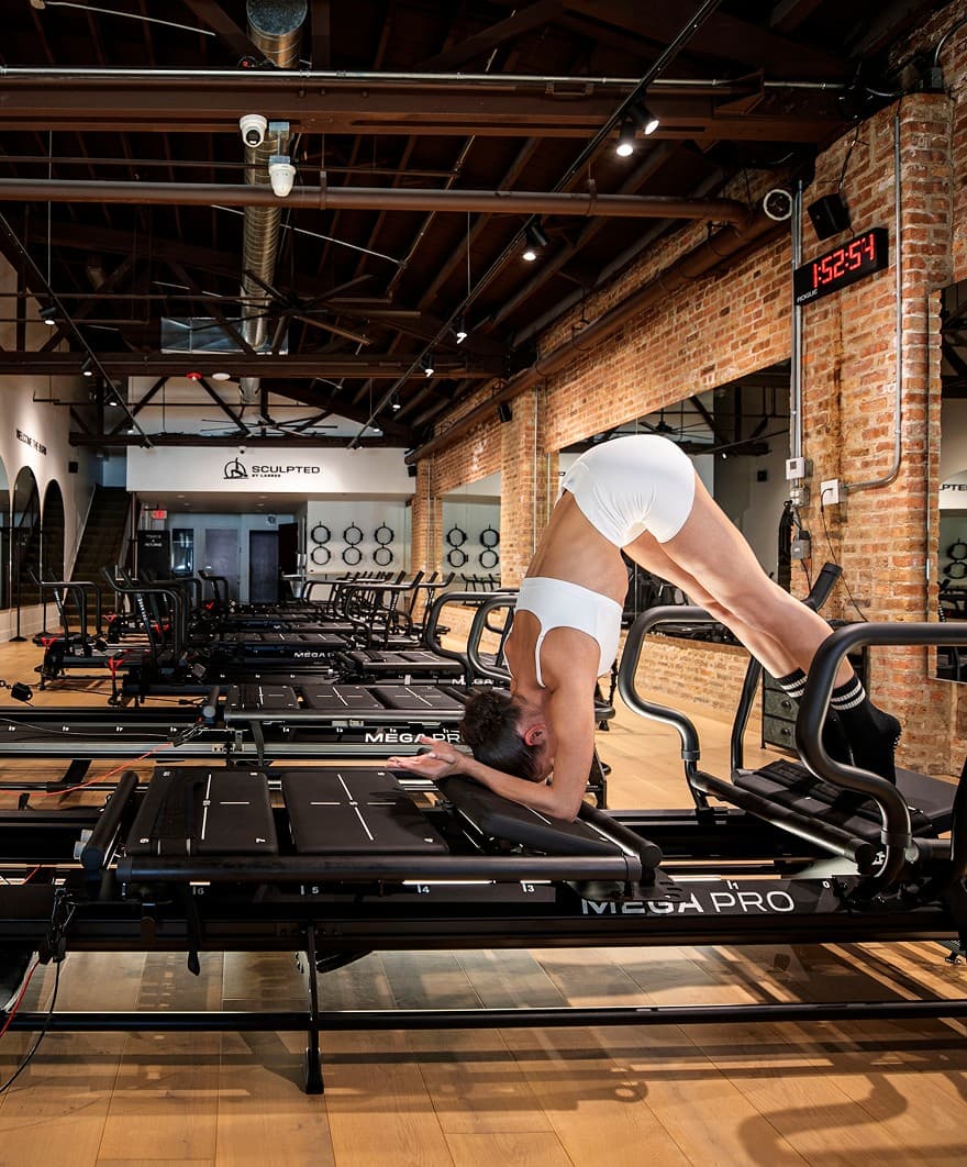 Woman exercising on Lagree machine